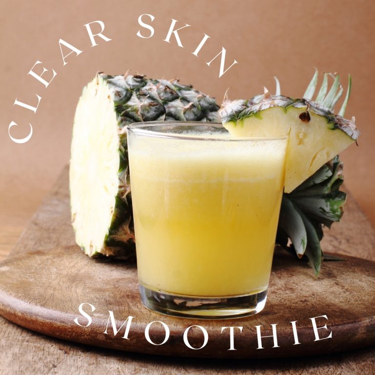Pineapple smoothie for clear skin on wooden board.