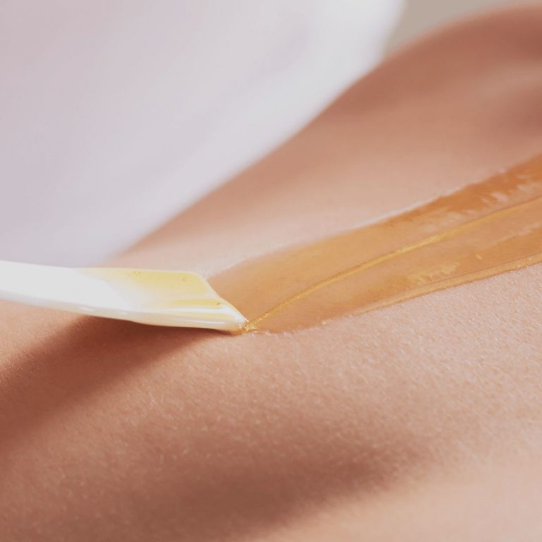 Close-up of waxing application on skin
